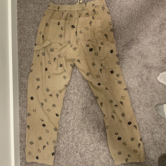Forever 21 beige corduroy pants with mushroom, yin yang, and dice prints on it. - Picture 2 of 3